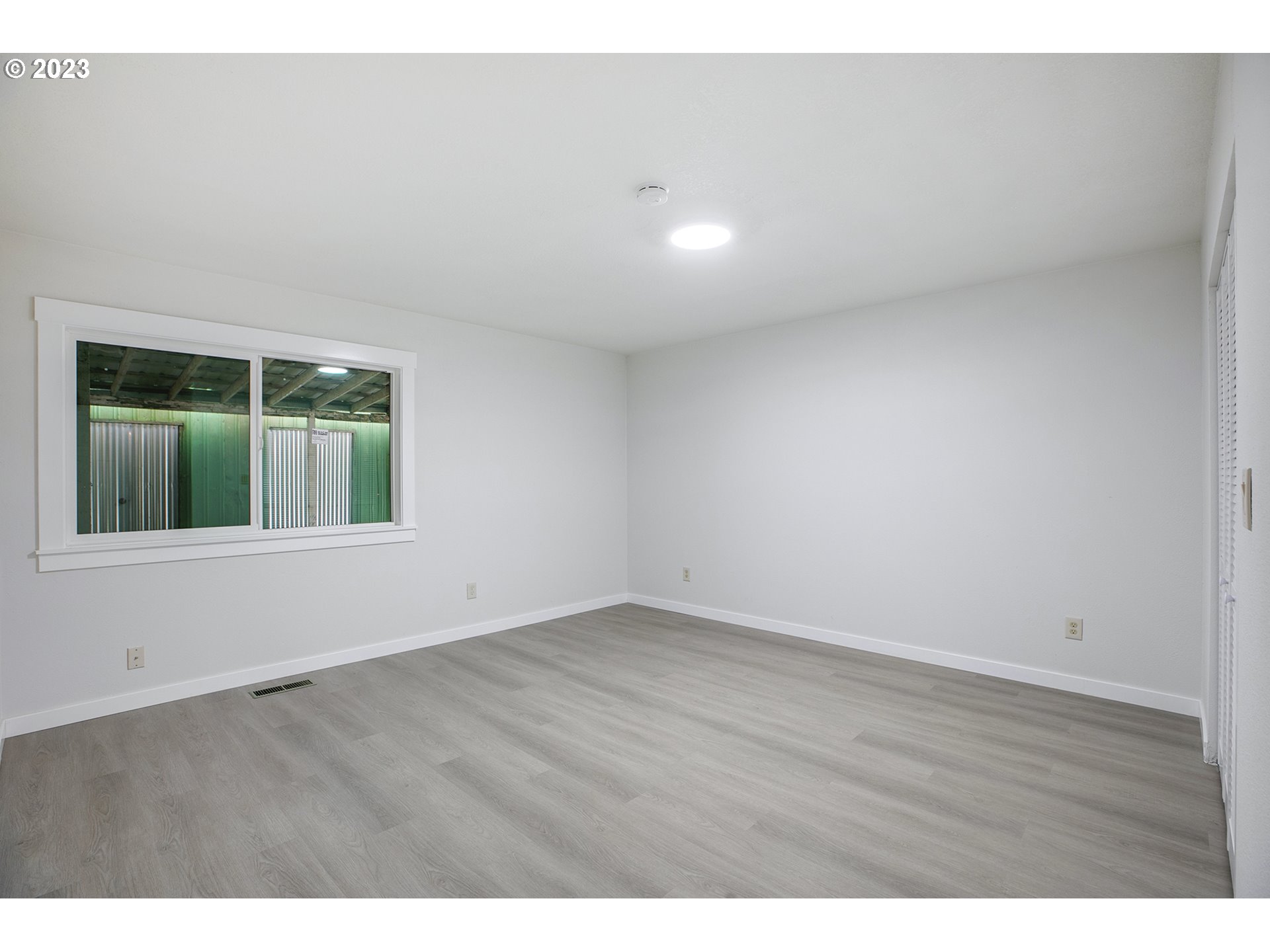 25331 South Larkin Road Beavercreek, OR 97004 - Photo 27 of 44 a view of an empty room with wooden floor and windows