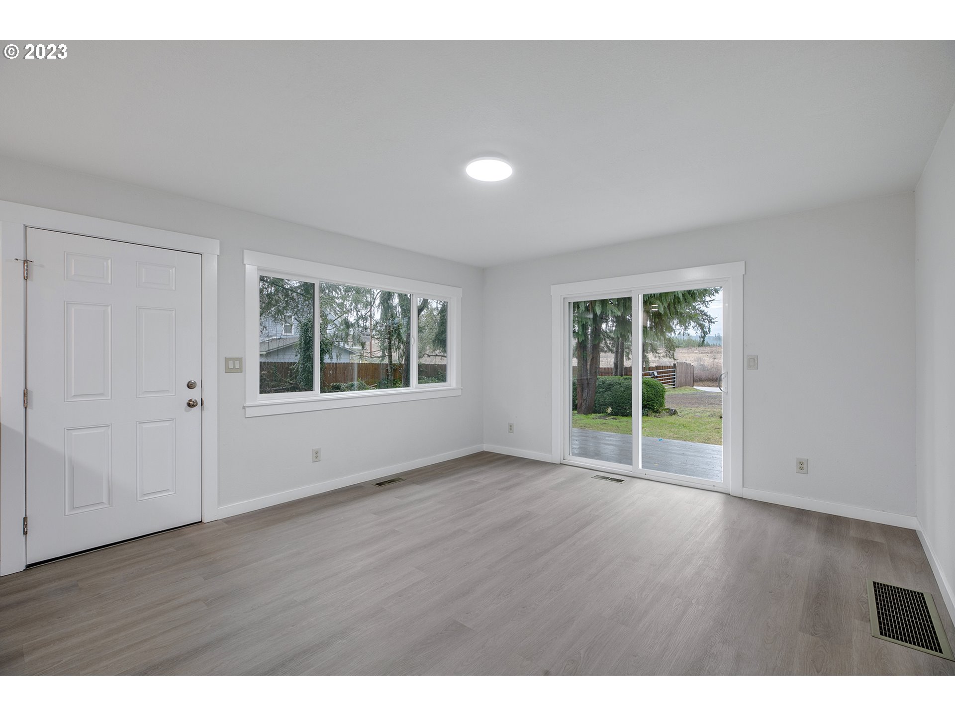 25331 South Larkin Road Beavercreek, OR 97004 - Photo 5 of 44 a view of an empty room with wooden floor and a window