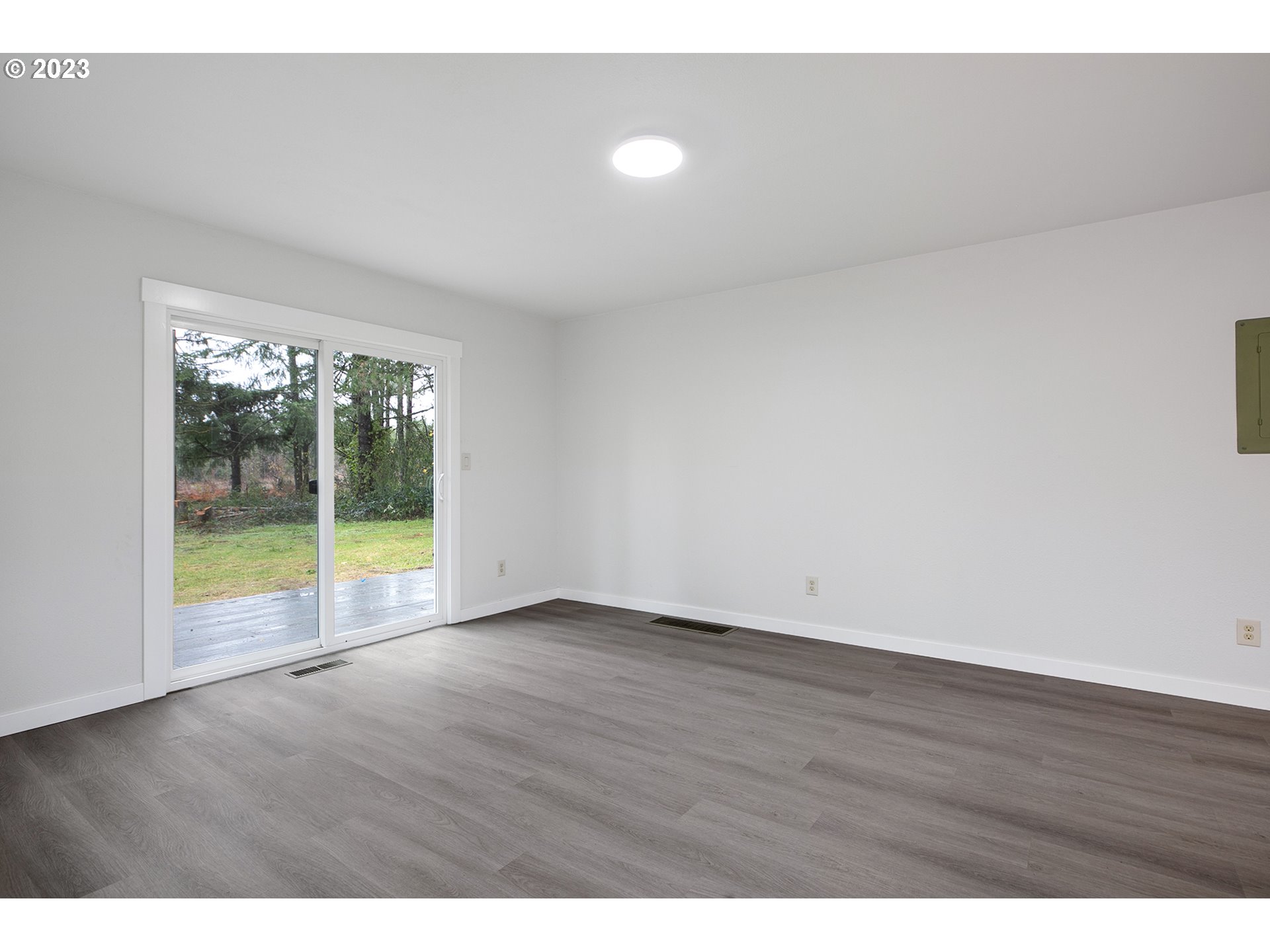 25331 South Larkin Road Beavercreek, OR 97004 - Photo 9 of 44 a view of an empty room with wooden floor and a window