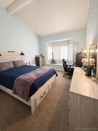 a spacious bedroom with a bed and window