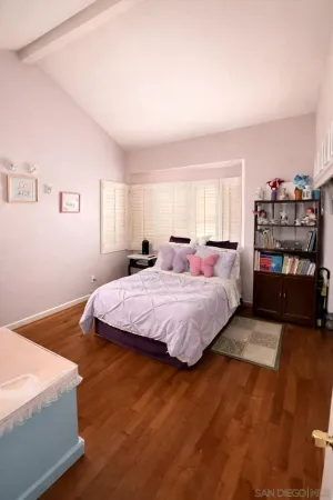 a spacious bedroom with a bed and a book shelf