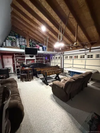 a living room with lots of furniture and clutter