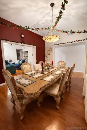 a dining room with furniture and a chandelier