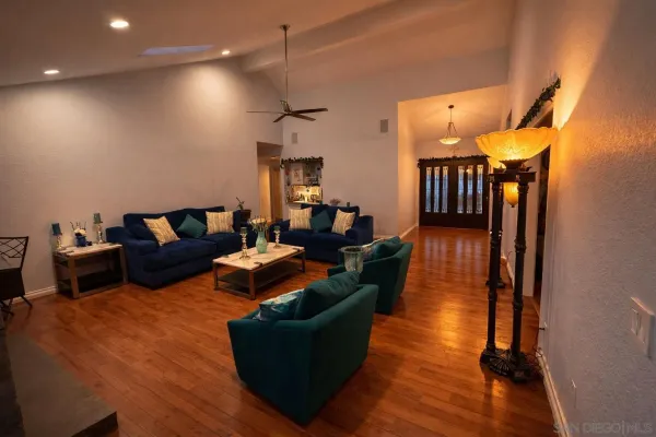 a living room with furniture and a wooden floor