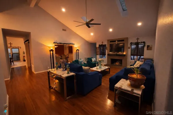 a living room with fireplace furniture and a wooden floor