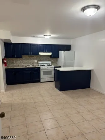a kitchen with stainless steel appliances a sink and cabinets