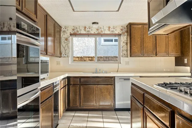 a kitchen with stainless steel appliances granite countertop a stove and a sink