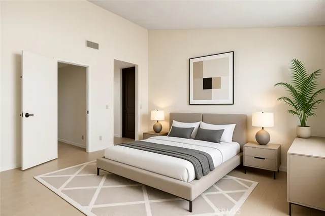 a bedroom with a bed and a potted plant