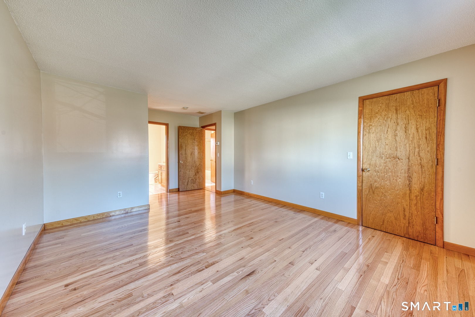 57 4 Rod Road Berlin, CT 06037 - Photo 14 of 31 a view of an empty room with wooden floor and a window