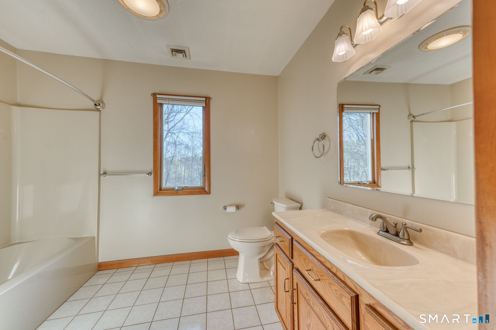 57 4 Rod Road Berlin, CT 06037 - Photo 15 of 31 a bathroom with a granite countertop sink mirror vanity bathtub and a shower