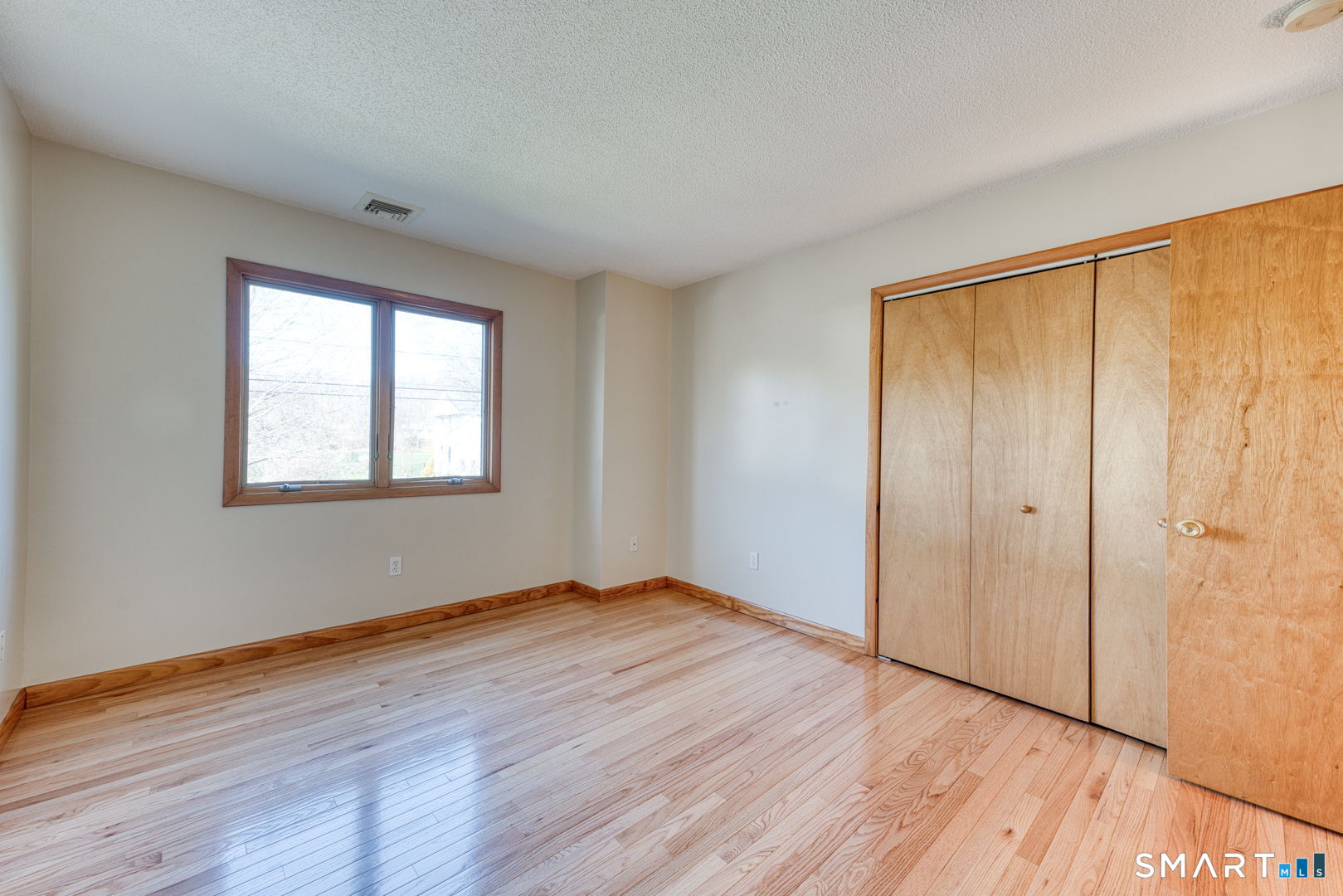 57 4 Rod Road Berlin, CT 06037 - Photo 16 of 31 a view of an empty room with wooden floor and a window