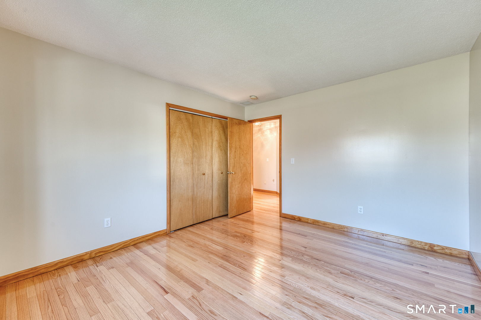57 4 Rod Road Berlin, CT 06037 - Photo 17 of 31 a view of an empty room with wooden floor