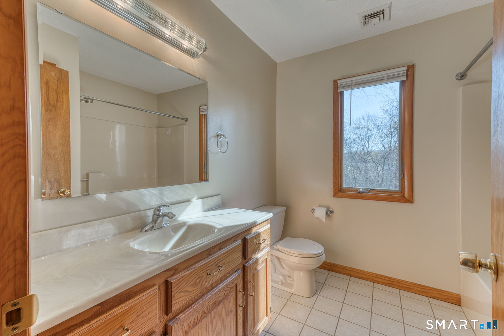 57 4 Rod Road Berlin, CT 06037 - Photo 18 of 31 a bathroom with a granite countertop sink a toilet and a mirror