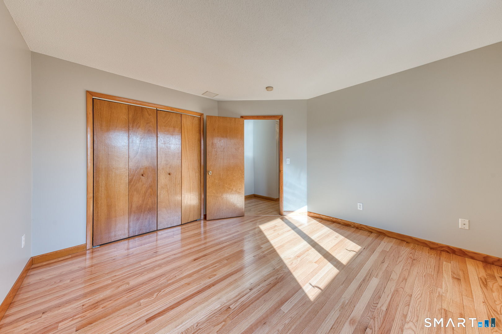57 4 Rod Road Berlin, CT 06037 - Photo 20 of 31 a view of empty room with wooden floor and fan