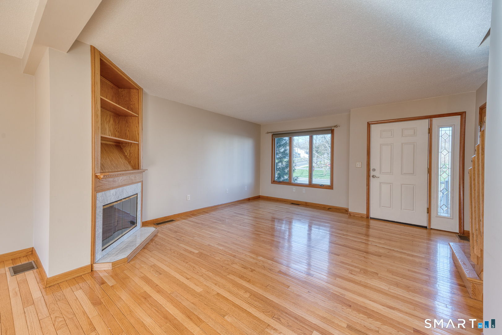 57 4 Rod Road Berlin, CT 06037 - Photo 4 of 31 a view of an empty room with window and wooden floor