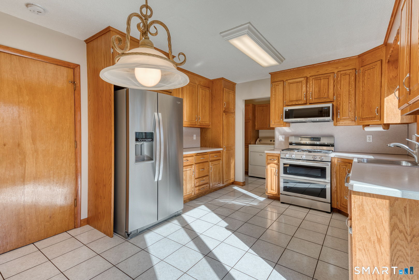 57 4 Rod Road Berlin, CT 06037 - Photo 8 of 31 a kitchen with granite countertop a refrigerator and a stove top oven