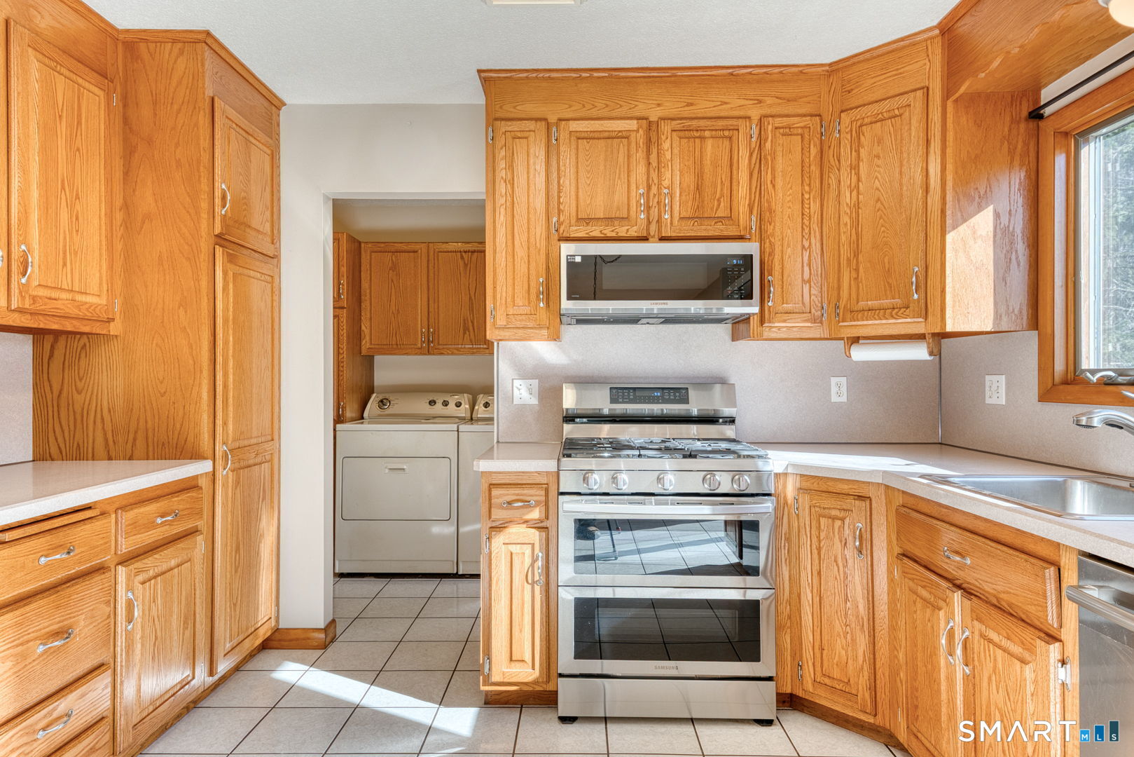 57 4 Rod Road Berlin, CT 06037 - Photo 10 of 31 a kitchen with a stove microwave and sink