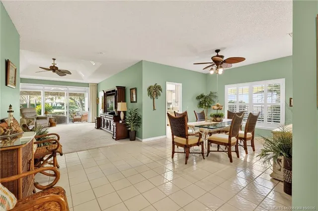 a view of a dining room with furniture and a potted plant