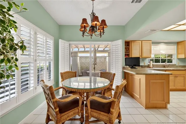 a kitchen with granite countertop a refrigerator and a stove top oven