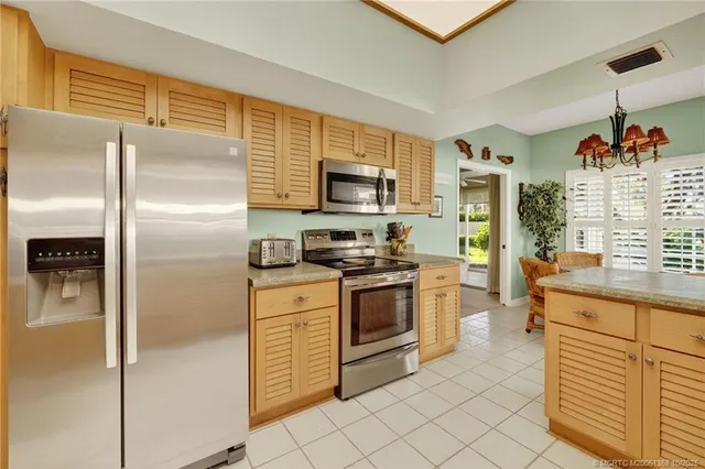 a bedroom with a bed and dresser with mirror