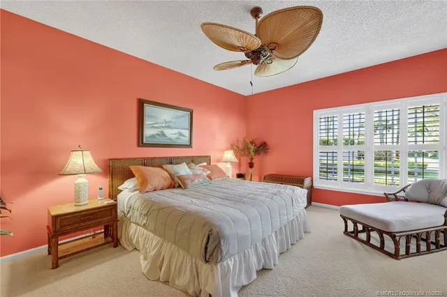 a bedroom with a bed and dresser with wooden floor