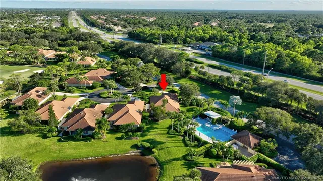a view of a backyard with plants and outdoor seating