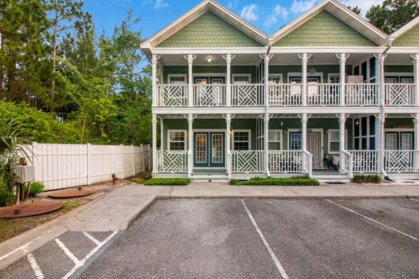 a front view of a house with a patio and a yard