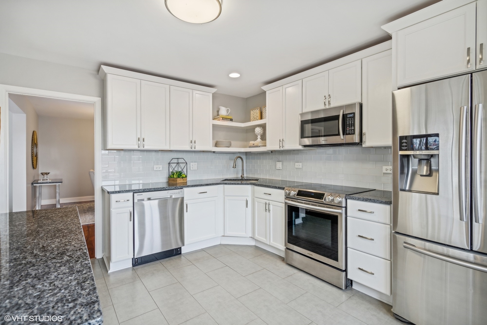 715 Ridge Road, Unit 4A Wilmette, IL 60091 - Photo 7 of 17 a kitchen with white cabinets stainless steel appliances and a sink