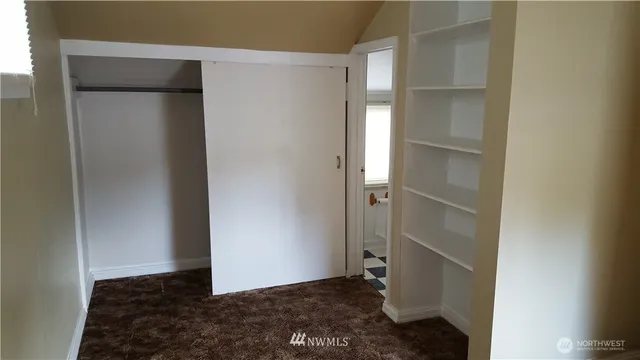 a view of walk in closet with empty racks