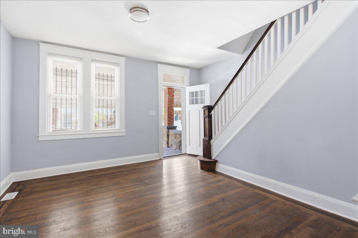 1231 North Potomac Street Baltimore, MD 21213 - Photo 5 of 25 a view of entryway with wooden floor and stairs