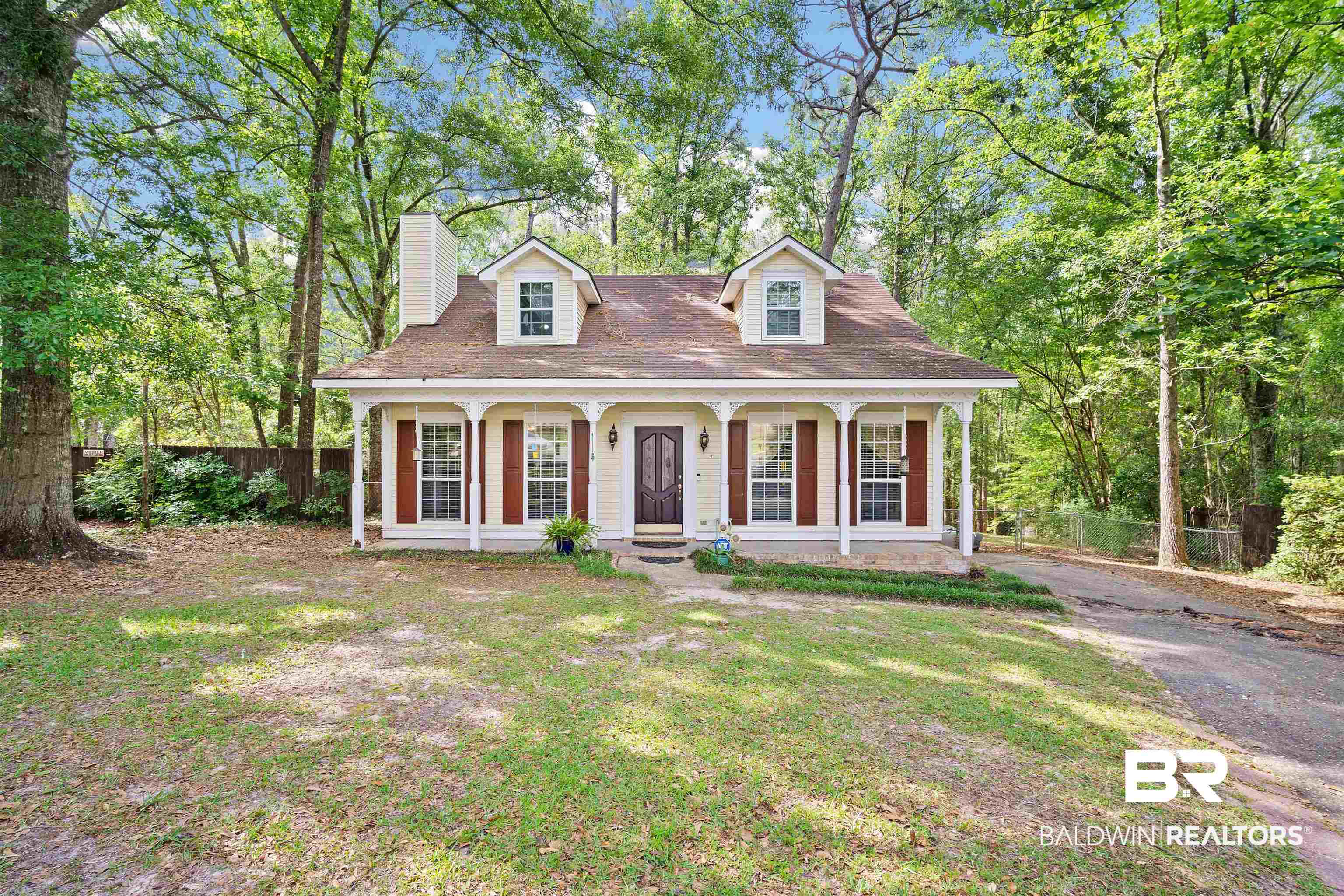2823 Woodland Road Mobile, AL 36693 - Photo 1 of 29 New england style home with fence, a porch, a chimney, and a front yard
