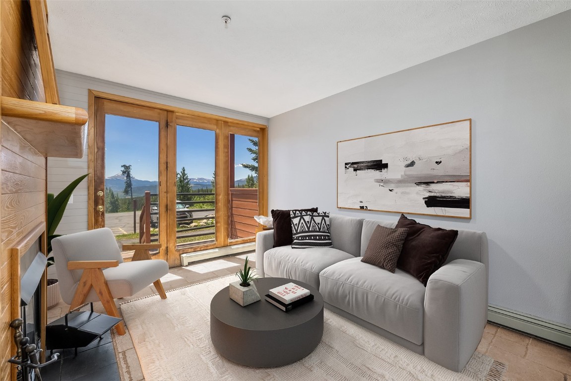 91400 Ryan Gulch Road, Unit 408B Silverthorne, CO 80498 - Photo 12 of 26 a living room with furniture and a large window