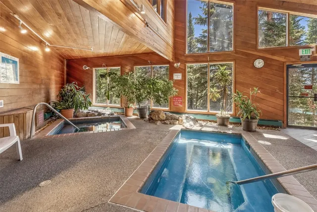 a view of a swimming pool with a table and chairs