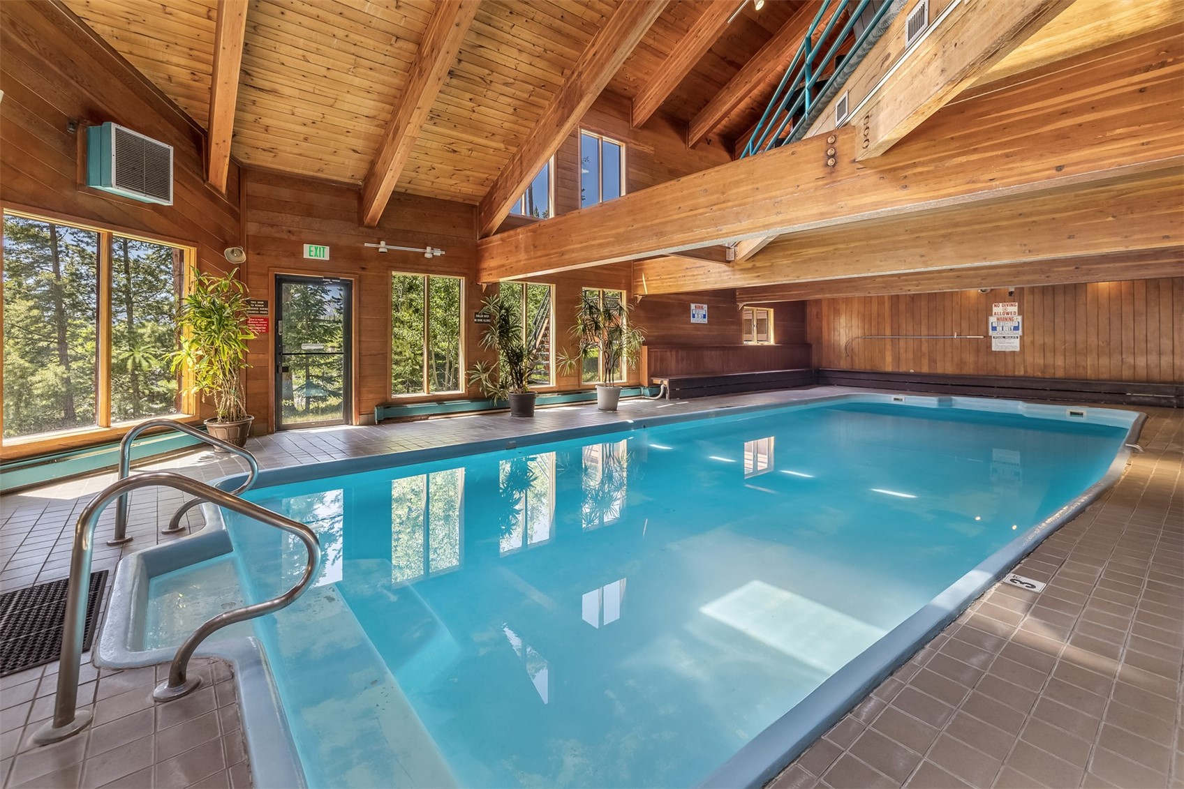 91400 Ryan Gulch Road, Unit 408B Silverthorne, CO 80498 - Photo 18 of 25 a view of a swimming pool with a table and chairs