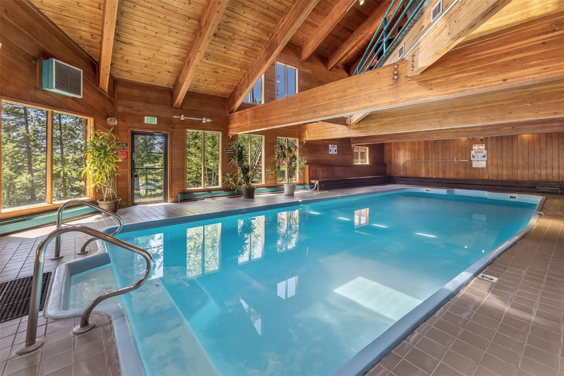 91400 Ryan Gulch Road, Unit 408B Silverthorne, CO 80498 - Photo 19 of 26 a view of a swimming pool with a table and chairs
