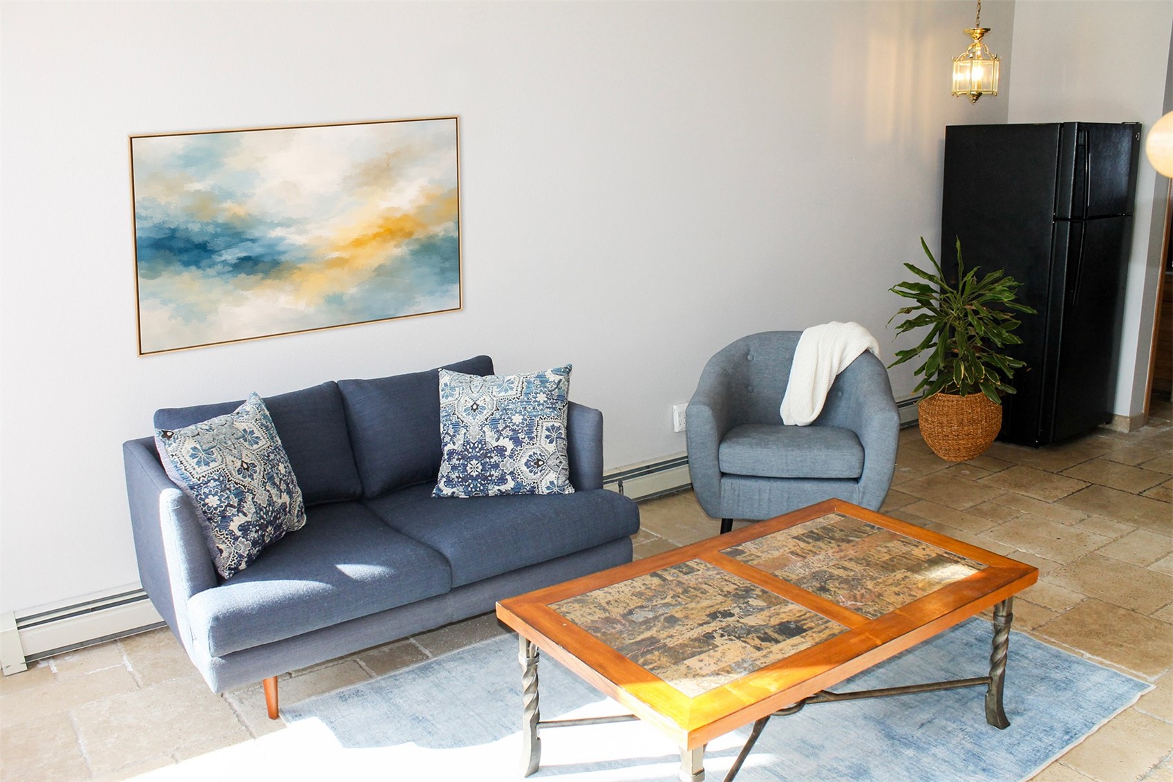 91400 Ryan Gulch Road, Unit 408B Silverthorne, CO 80498 - Photo 2 of 25 a living room with furniture and a potted plant