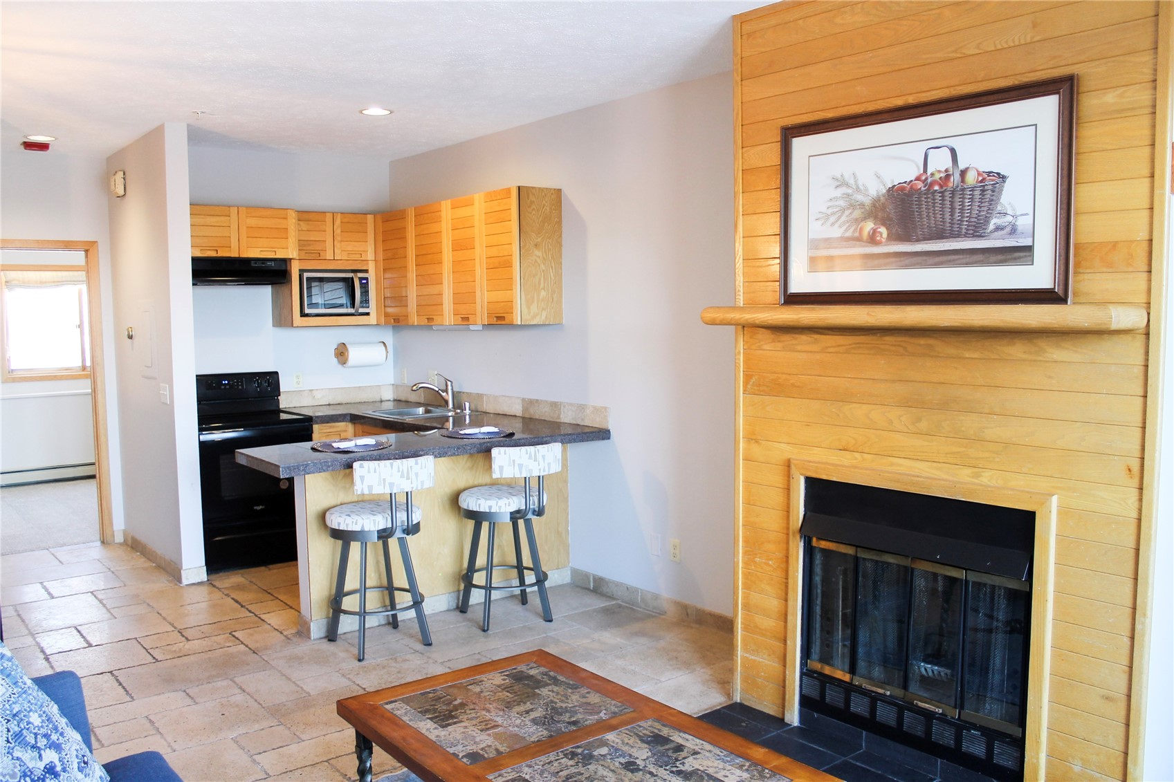 91400 Ryan Gulch Road, Unit 408B Silverthorne, CO 80498 - Photo 3 of 25 a living room with stainless steel appliances kitchen island granite countertop furniture a rug and a window