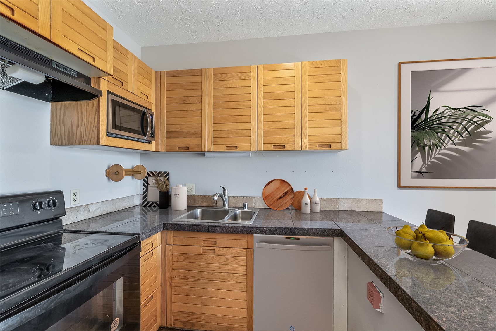 91400 Ryan Gulch Road, Unit 408B Silverthorne, CO 80498 - Photo 4 of 25 a kitchen with stainless steel appliances granite countertop a sink stove and cabinets