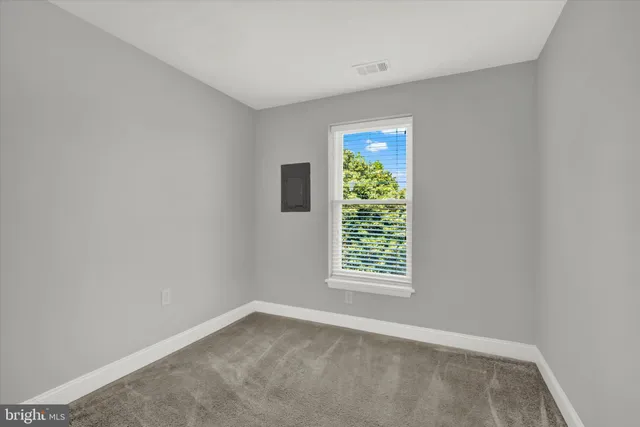 an empty room with windows and closet