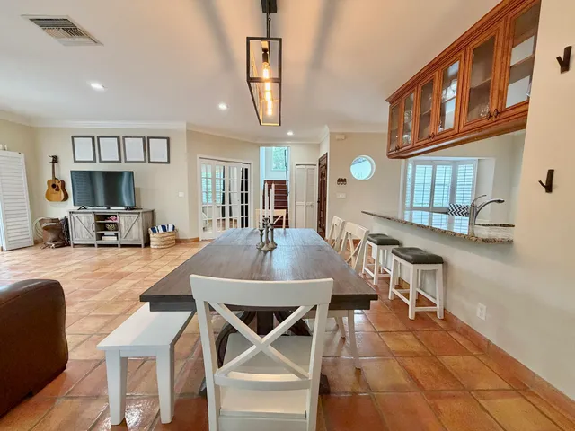 a large kitchen with stainless steel appliances granite countertop a large window and a sink