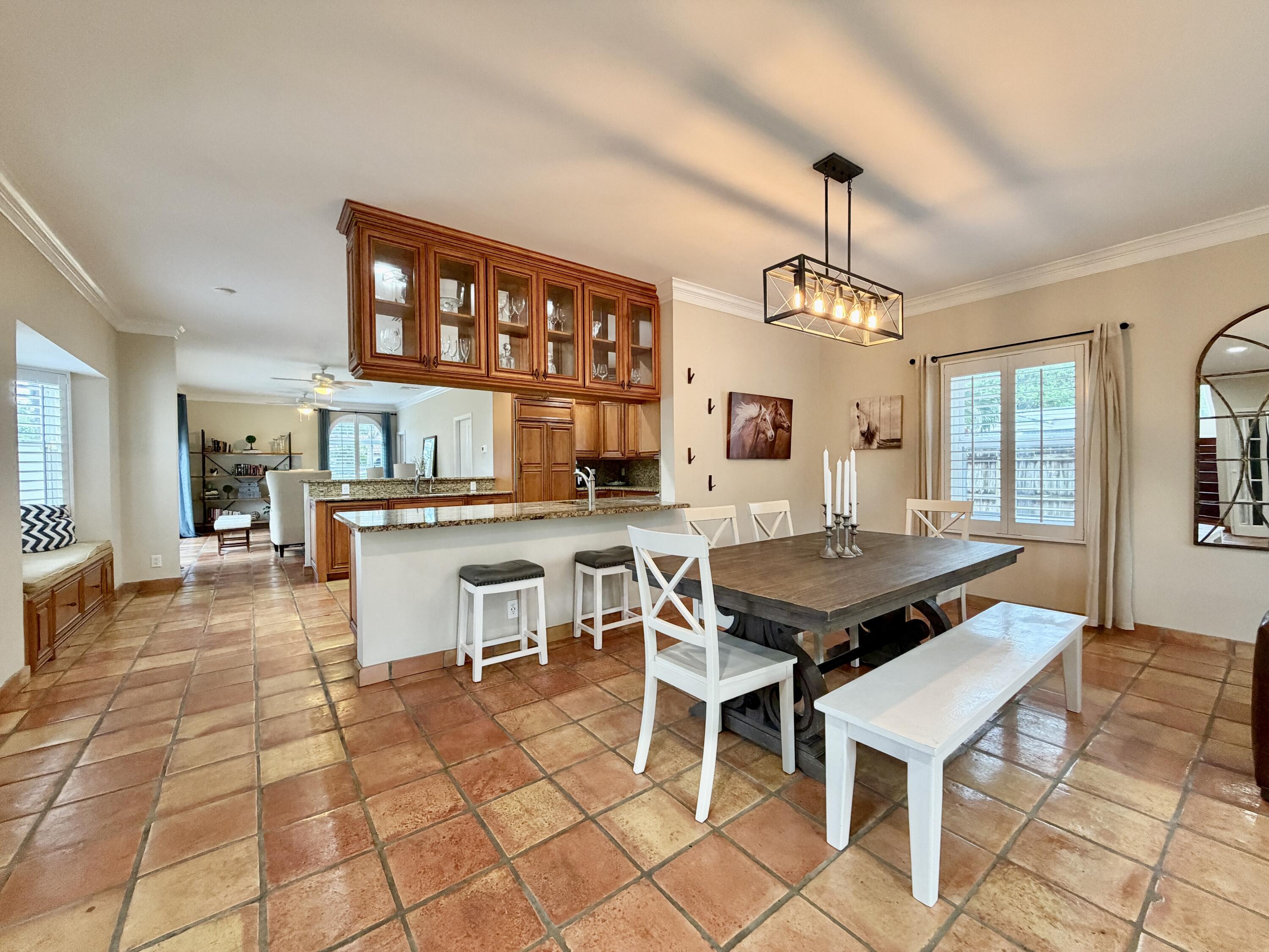 6401 Travis Road West Palm Beach, FL 33406 - Photo 15 of 99 a dining hall with stainless steel appliances kitchen island granite countertop a dining table chairs and view of living room