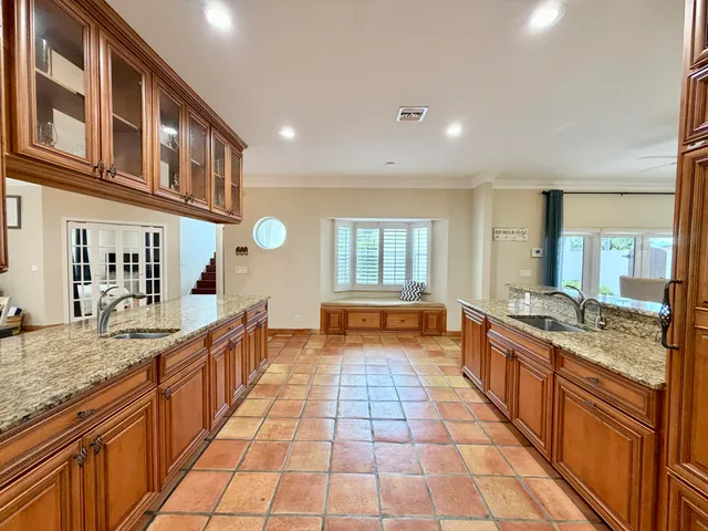 a kitchen with white cabinets and black appliances