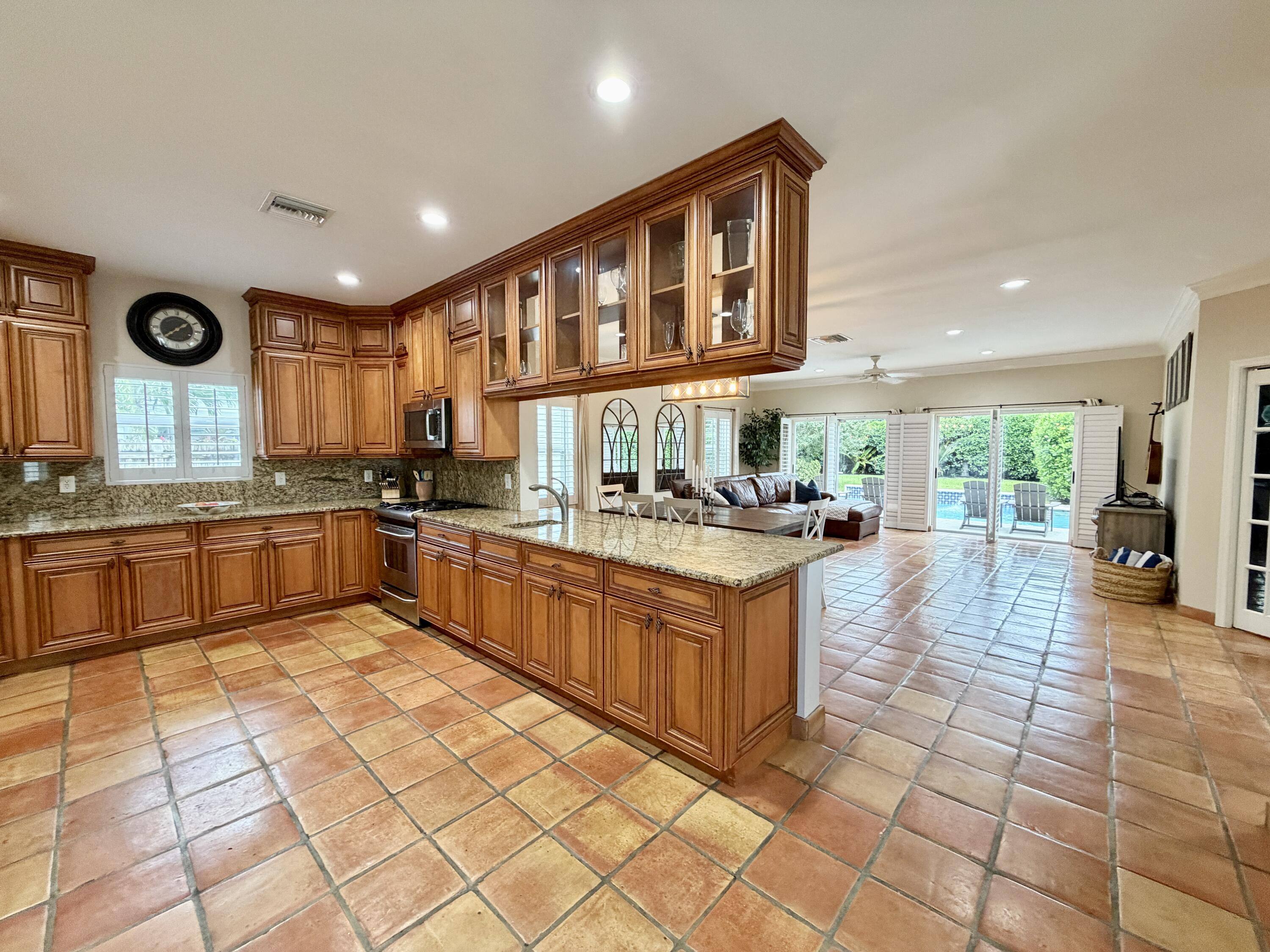 6401 Travis Road West Palm Beach, FL 33406 - Photo 20 of 99 a kitchen with stainless steel appliances granite countertop a stove a sink and a refrigerator