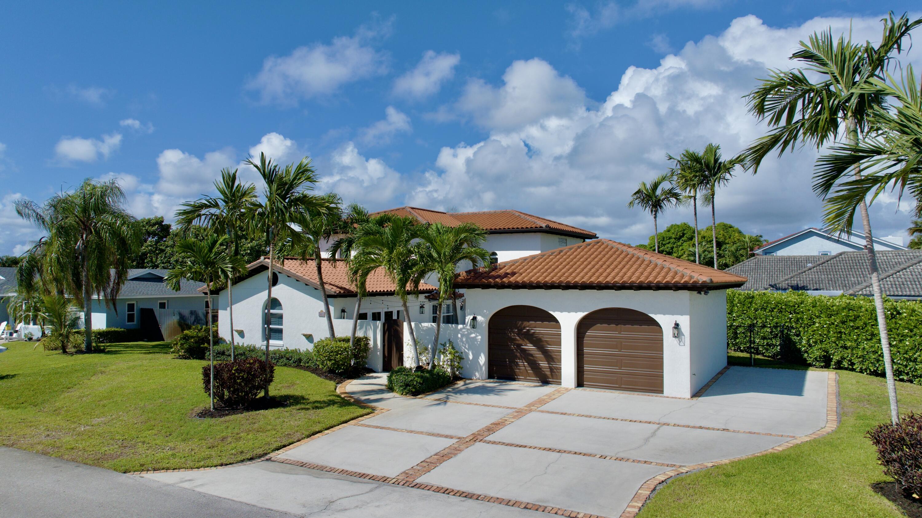 6401 Travis Road West Palm Beach, FL 33406 - Photo 2 of 99 a front view of a house with garden