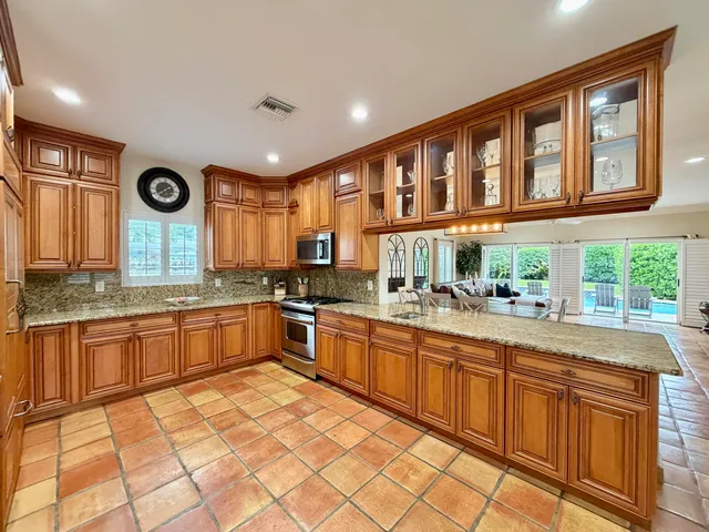 a view of swimming pool with a yard and large trees