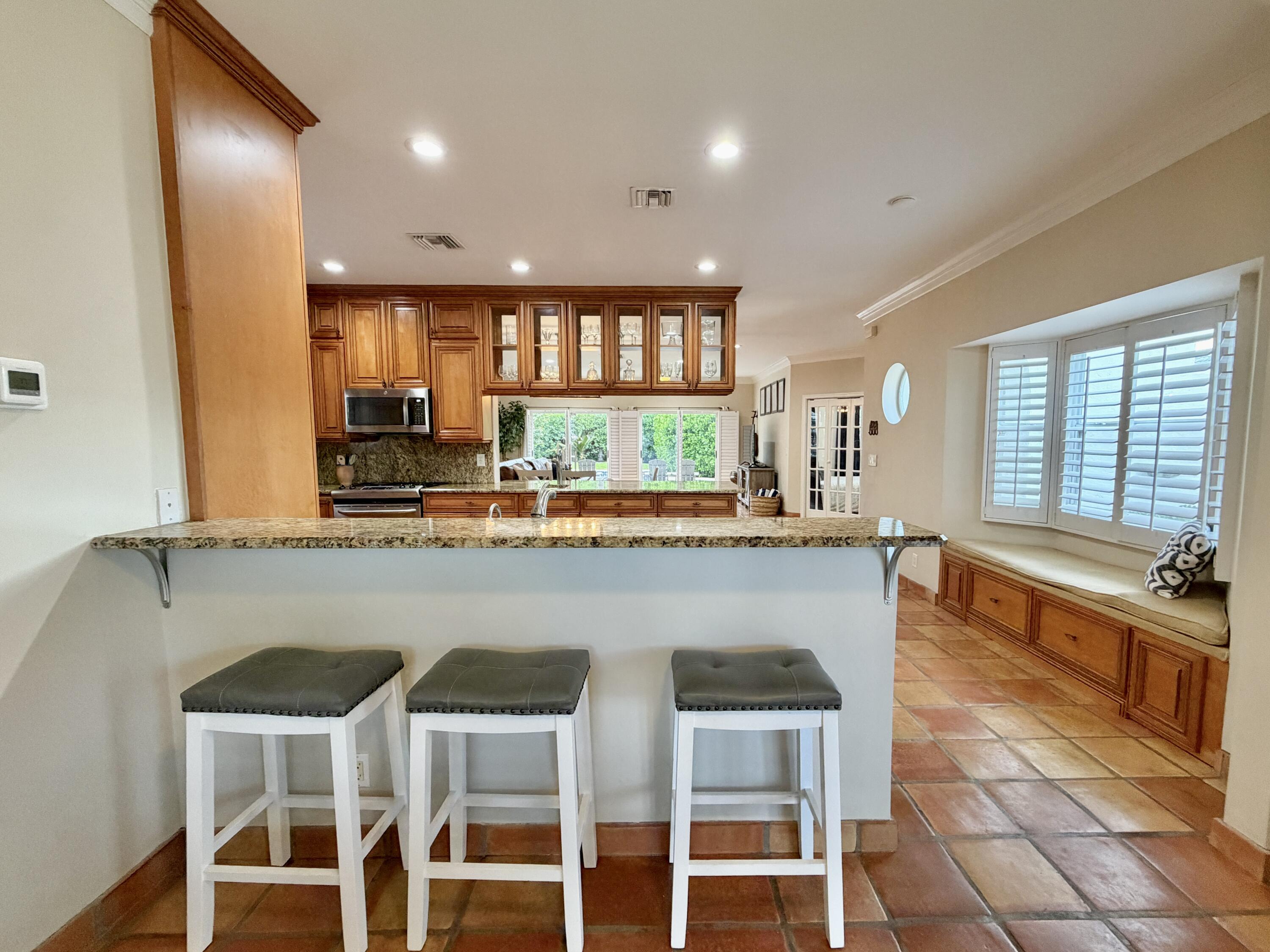 6401 Travis Road West Palm Beach, FL 33406 - Photo 26 of 99 a kitchen with a window and chairs
