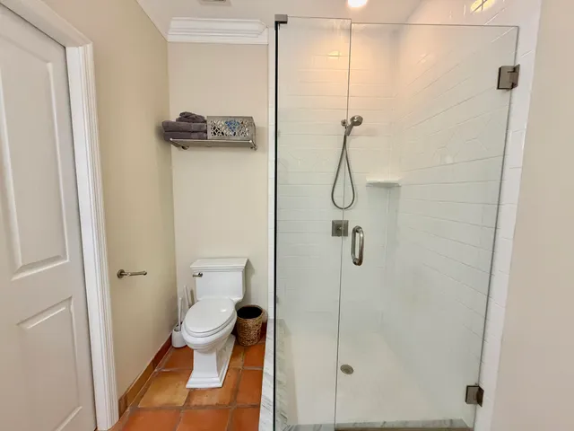 a bathroom with a granite countertop double vanity sink and a mirror