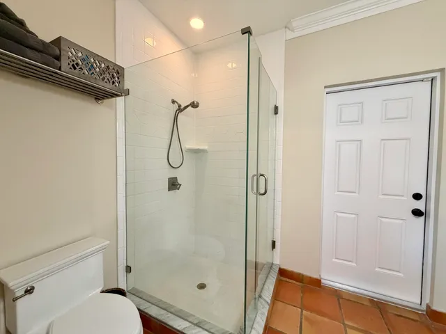 a bathroom with a granite countertop double vanity sink and a mirror