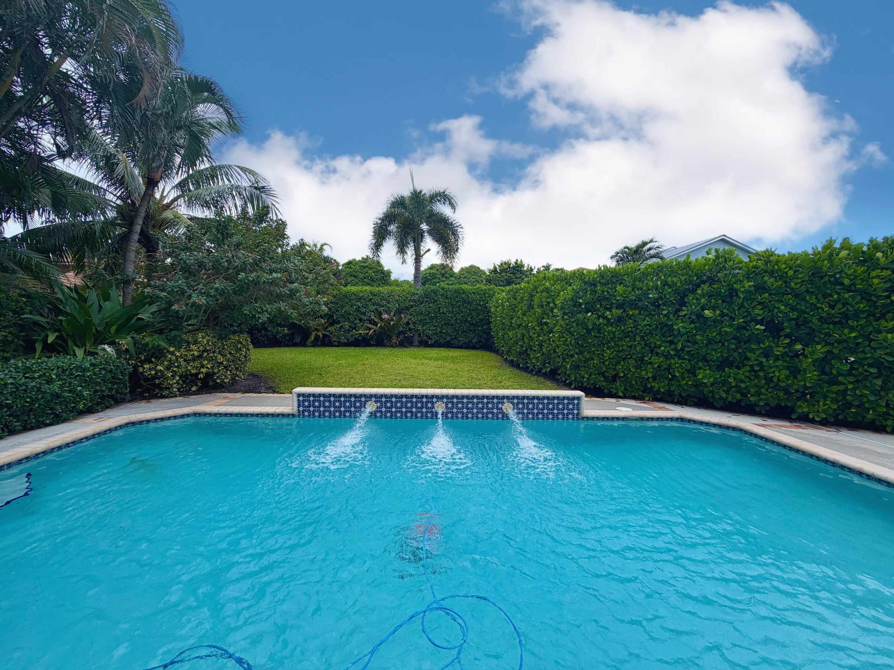 6401 Travis Road West Palm Beach, FL 33406 - Photo 44 of 99 a view of swimming pool with a yard and large trees