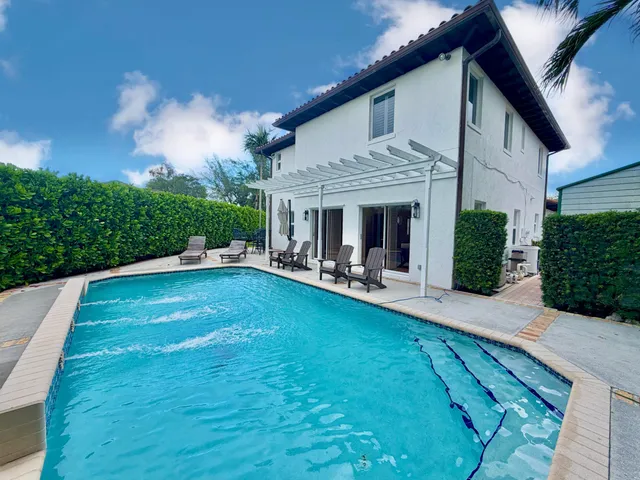 an aerial view of residential houses with outdoor space and street view